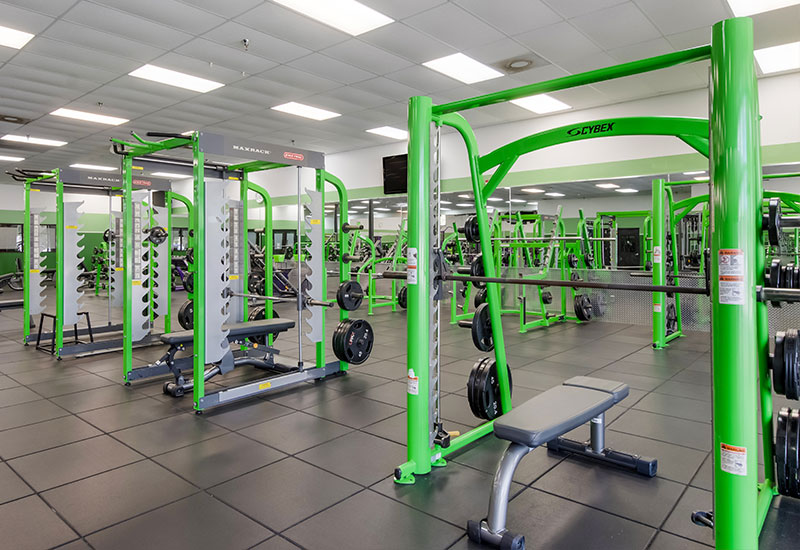 Green squat racks in the Sarasota YouFit Gym