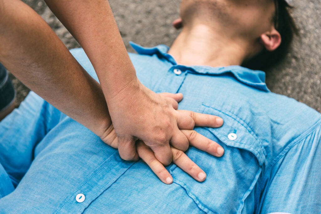 Hands doing CPR on a man