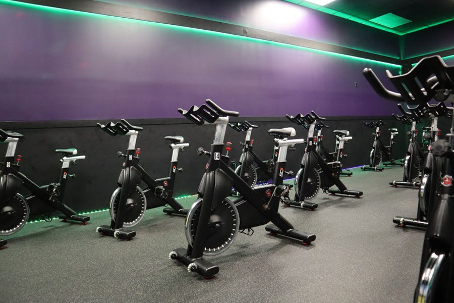 Stationary exercise bikes in an indoor YouFit cycling room